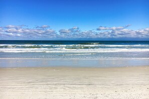 A beach with clear skies and waves. - A1A South St Augustine 2 Bedroom Oceanview Condo Sleeps 8 (St. Augustine)