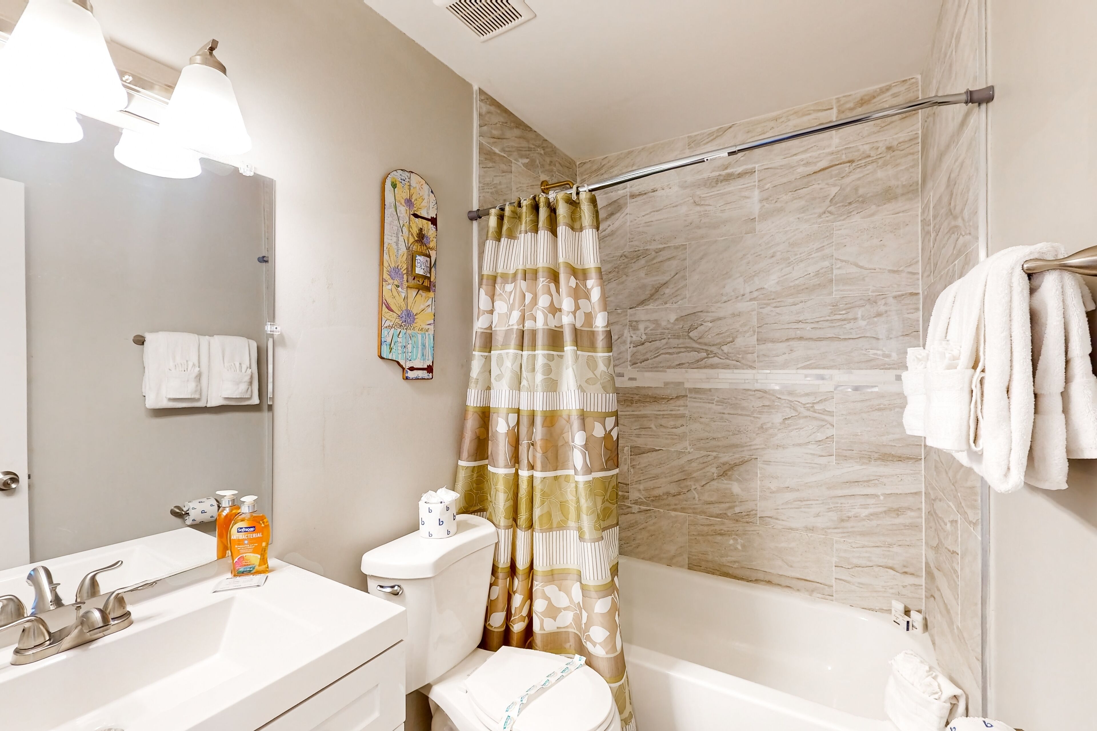 A bathroom with a toilet, sink, and bathtub.