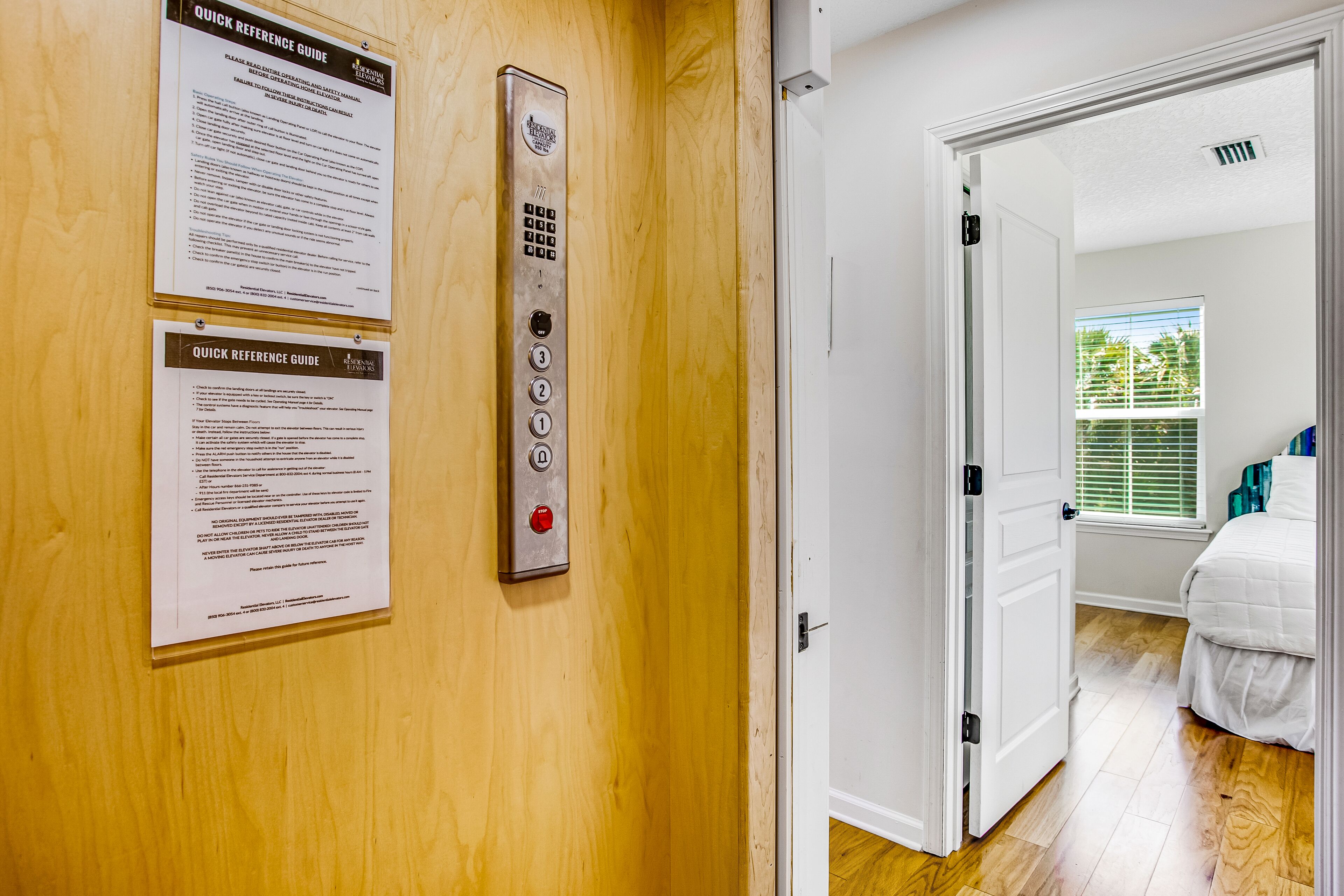 A residential elevator with a control panel and a door with a handle.