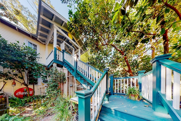 A wooden staircase with blue railings leading to a porch. - Charming Getaway w/ a Kitchenette & Free Wifi - Walk to the Beach (St. Simons Island)