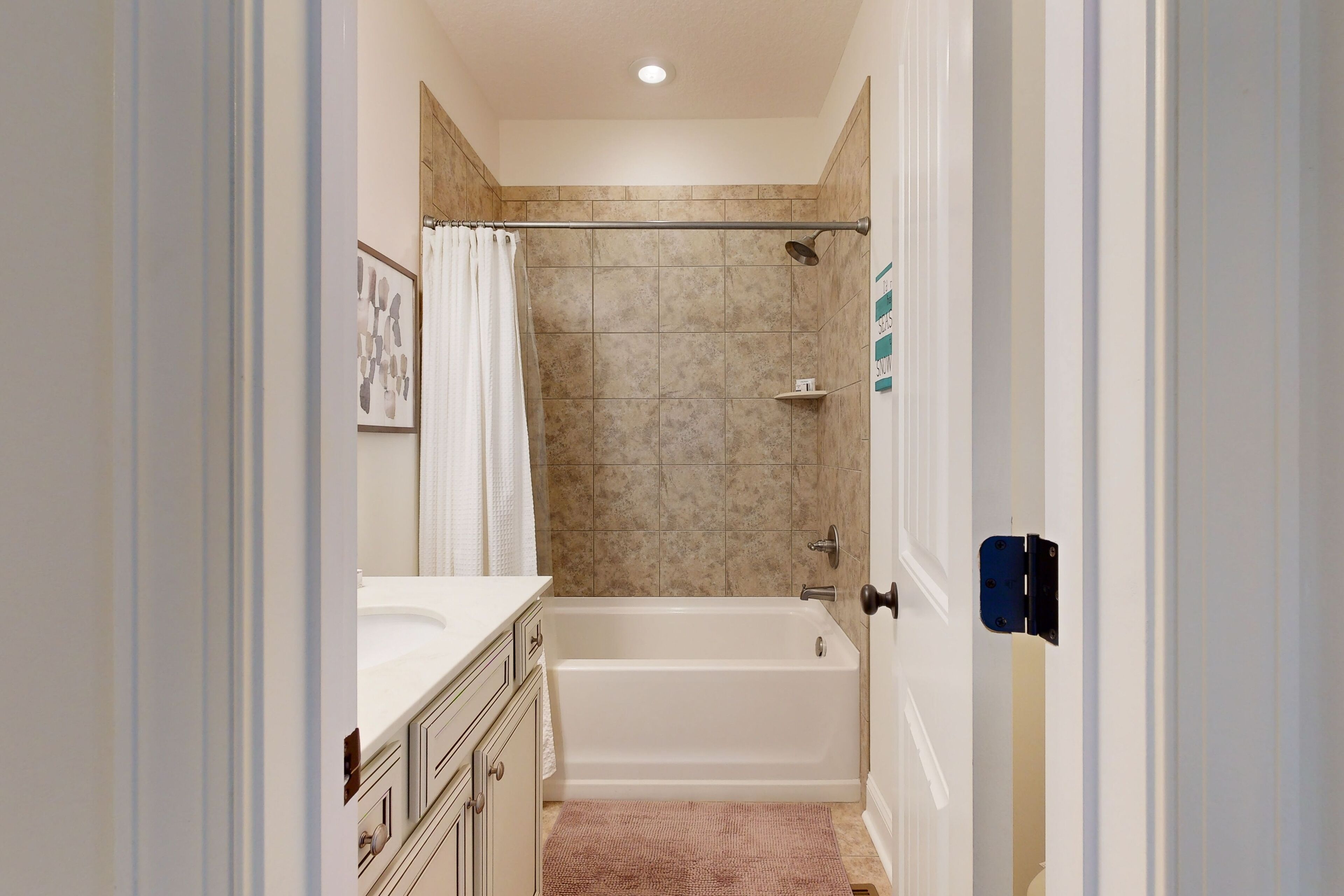A bathroom with a bathtub, a shower, and a sink.