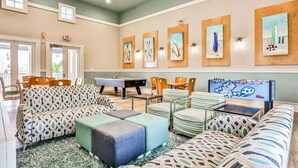 A spacious lounge area with patterned sofas, a pool table, and artwork on the walls. - Coastal Gem on the Golf Course w/ Shared Pool, & Beach Access - Dog-friendly (Palm Coast)
