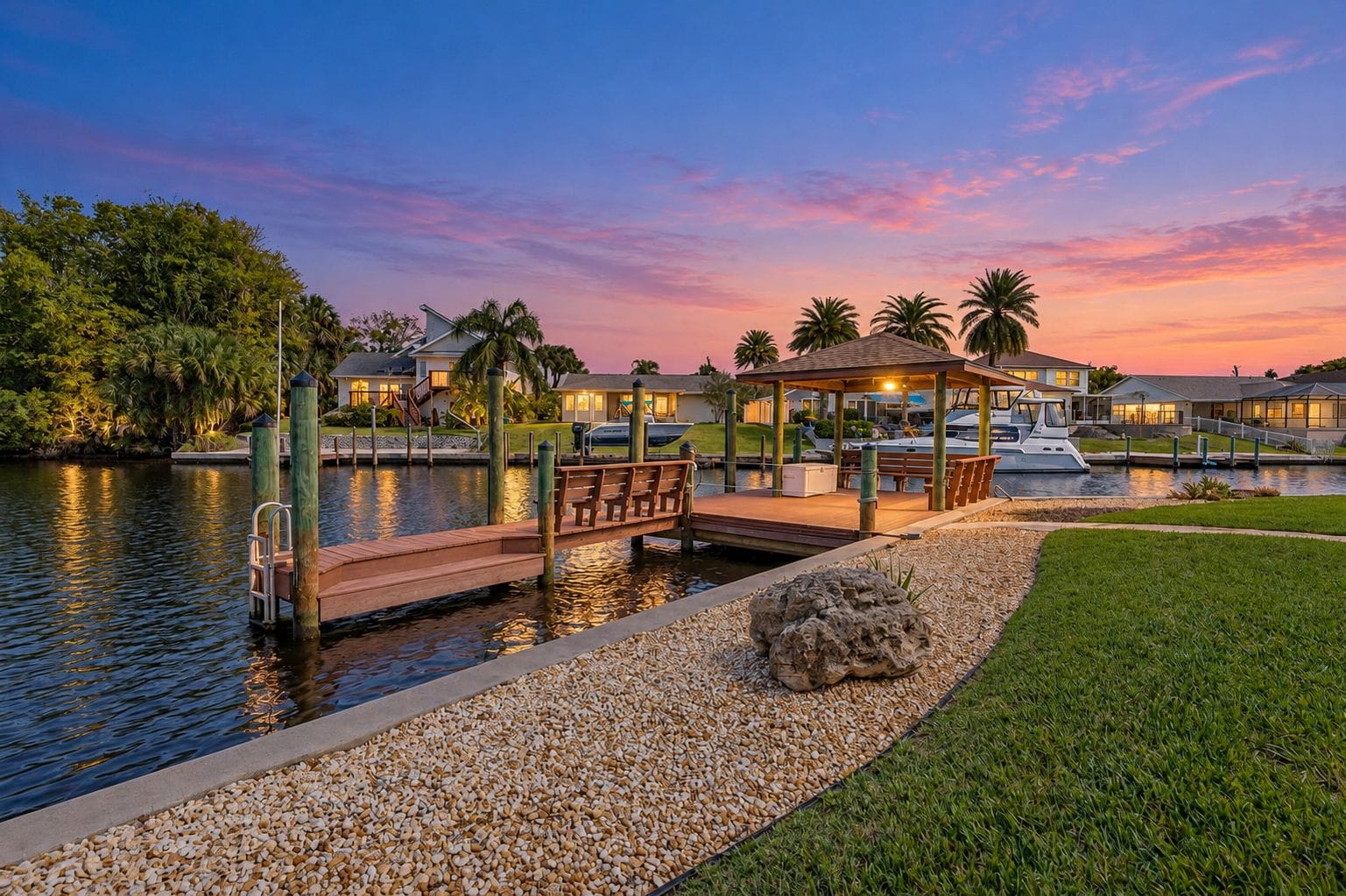 A waterfront property with a dock, a gazebo, and a boat.