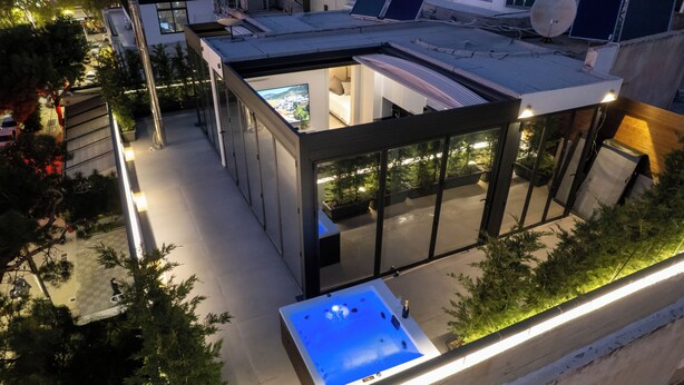 A modern rooftop with a glass-enclosed living area, a hot tub, and a pool. - Penthouse in the Heart of Glyfada (Glifada)