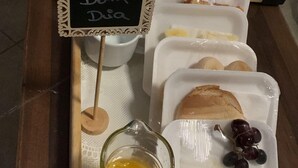 A breakfast buffet with various food items and drinks. - Hotel Londres ADE (Samambaia)
