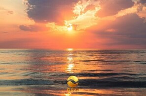 A sunset over the ocean with a beach ball in the foreground. - GSIH Hotel Diani (Diani Beach)