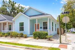 A single-story house with a front porch, a mailbox, and a stop sign. - Blue Bungalow · Walk Downtown · Near UF & Shands · Fenced Yard · PS5 (Gainesville)