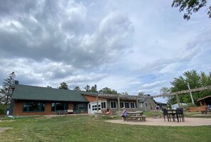 A building with a green roof, a covered patio area, and a playground. - Larrabee Lake Retreat - The Lodge & Cottage (New Auburn)