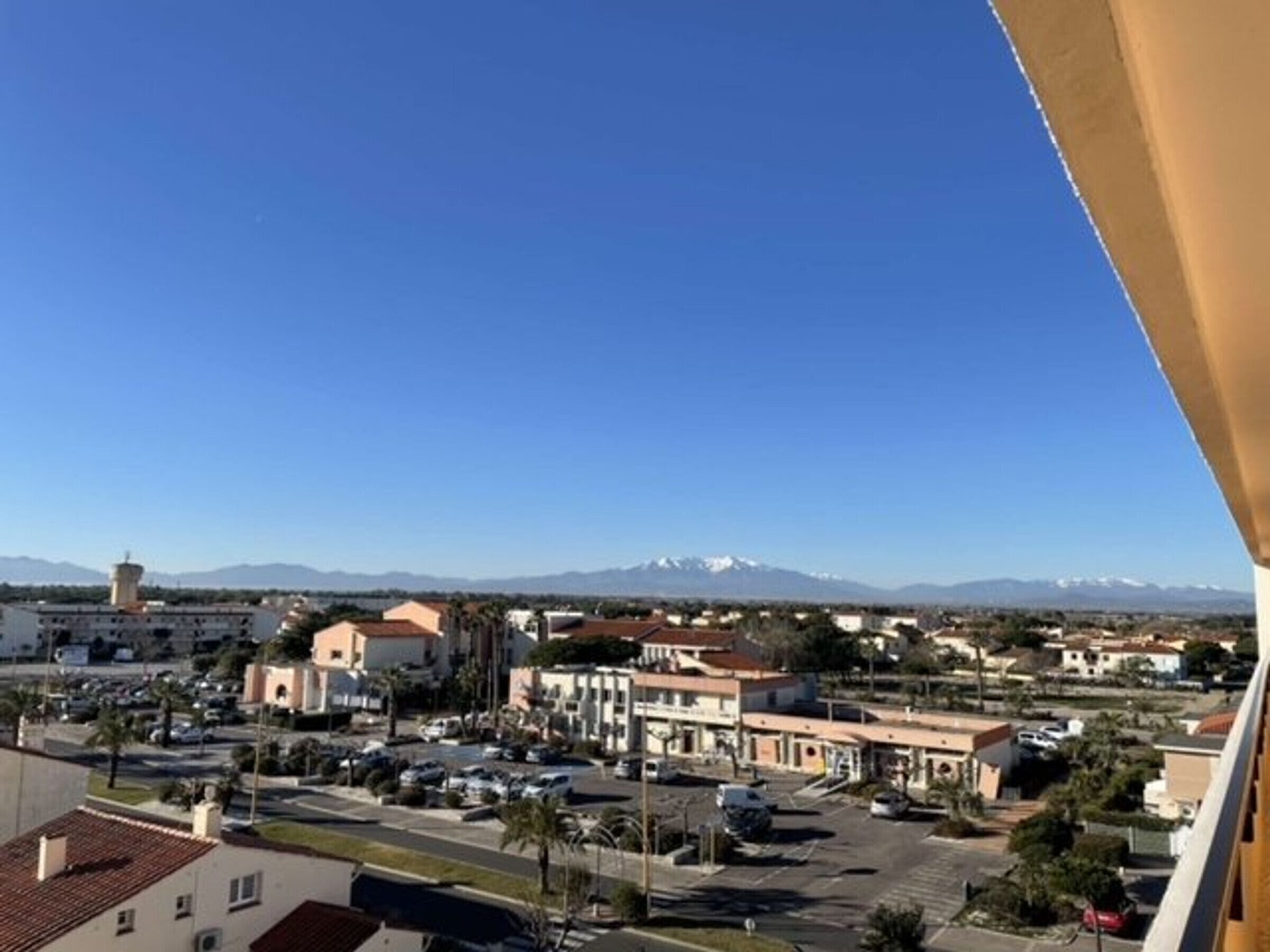 A residential area with a clear view of a mountain range in the distance.