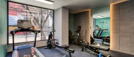 A gym with treadmills, stationary bikes, and weight machines.