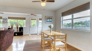A spacious living room with a wooden dining table, chairs, and a ceiling fan. - Dog-friendly Home With Beach Access & Deck - Snowbirds Welcome (St. Augustine)
