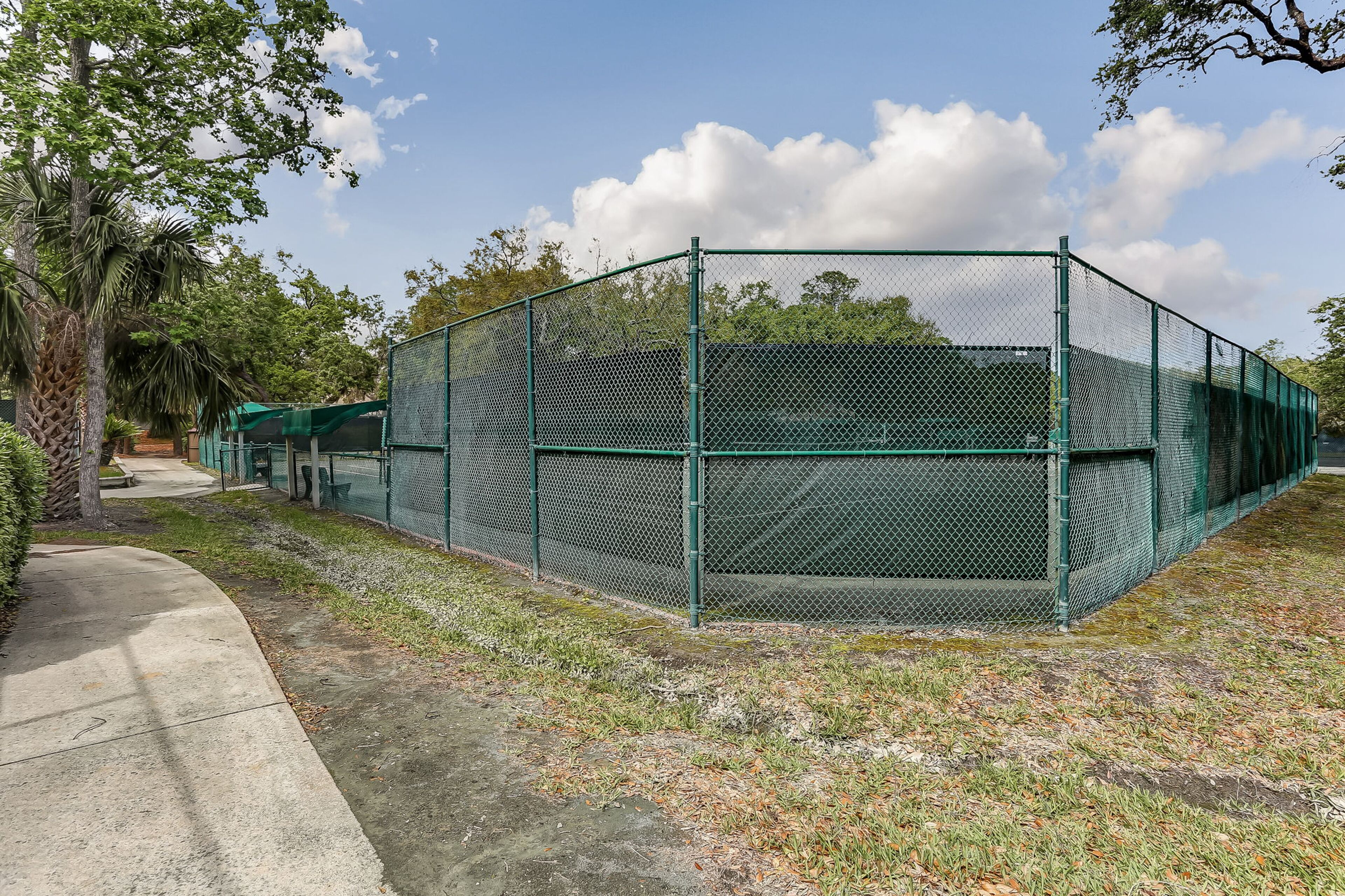 A fenced outdoor area with a concrete path.