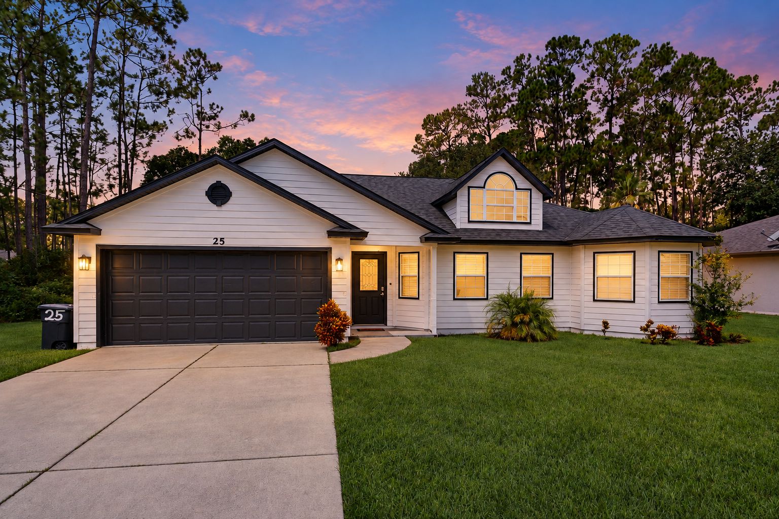 A two-story house with a garage, a well-maintained lawn, and a driveway.