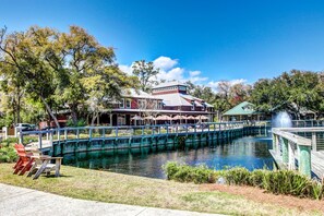 A riverside hotel with a bridge, outdoor seating, and a dock. - Dog-friendly Home in the Tennis Villas W/free Wifi, Shared Pool, Central AC (Fernandina Beach)