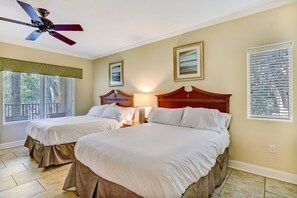 A hotel room with two beds, a ceiling fan, a window with blinds, and a lamp. - Dog-friendly Home in the Tennis Villas W/free Wifi, Shared Pool, Central AC (Fernandina Beach)