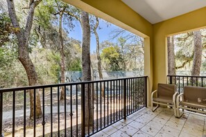 A balcony with a view of trees and a fence. - Dog-friendly Home in the Tennis Villas W/free Wifi, Shared Pool, Central AC (Fernandina Beach)