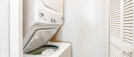 A front-loading washing machine with an ENERGY GUIDE label, a control panel with various settings, and a door with a handle.