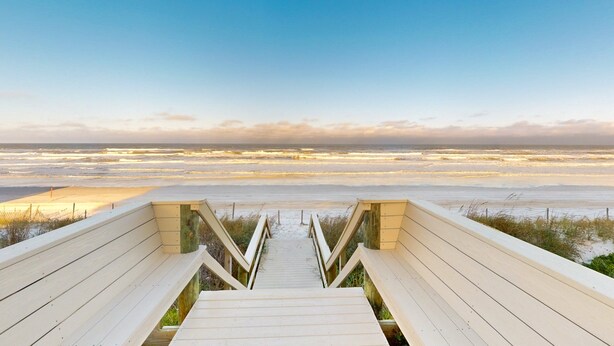 A wooden boardwalk leading to a beach with a clear view of the ocean. - First Floor Oceanfront Condo With Beach Access and Tennis Courts (St. Augustine)