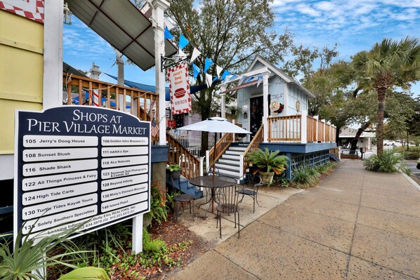A Pier Village Market with a sign listing shops like Jerry's Dog House and Sunset Slush. - Golden Isles Getaway - Walk to the Beach (St. Simons Island)