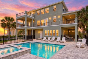 A multi-story building with a swimming pool and lounge chairs. - Ocean View 'atlantic Dream' W/pool & Spa, Wraparound Balcony, Steps to Beach (St. Augustine)