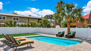 A swimming pool with lounge chairs and a white fence. - Home 1 Block From 2 Beaches W/private Pool, High-speed Wifi & Central AC (St. Augustine)