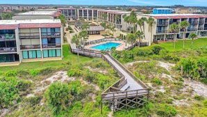A resort with multiple buildings, a central pool, and a boardwalk. - Modern Oceanview Condo With Multiple Balconies, Pool & W/D - Beach Access (St. Augustine)