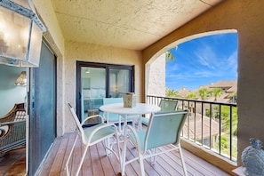 A balcony with a table and chairs, a view of the surrounding area, and a railing. - Newly Renovated Spacious Villa w/ Ocean Views, Pool & Beach Access (Fernandina Beach)