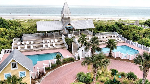 A resort with a pool, lounge chairs, and a beach view. - Luxury Cottage With Pools & Multiple Decks, 1/2 Block to Beach (St. Simons Island)