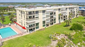 A multi-story hotel with a rooftop pool, a well-maintained lawn, and a view of the surrounding landscape. - Newly Decorated Ground-floor Suite Steps From Beach and Pool W/views, Wifi (St. Augustine)