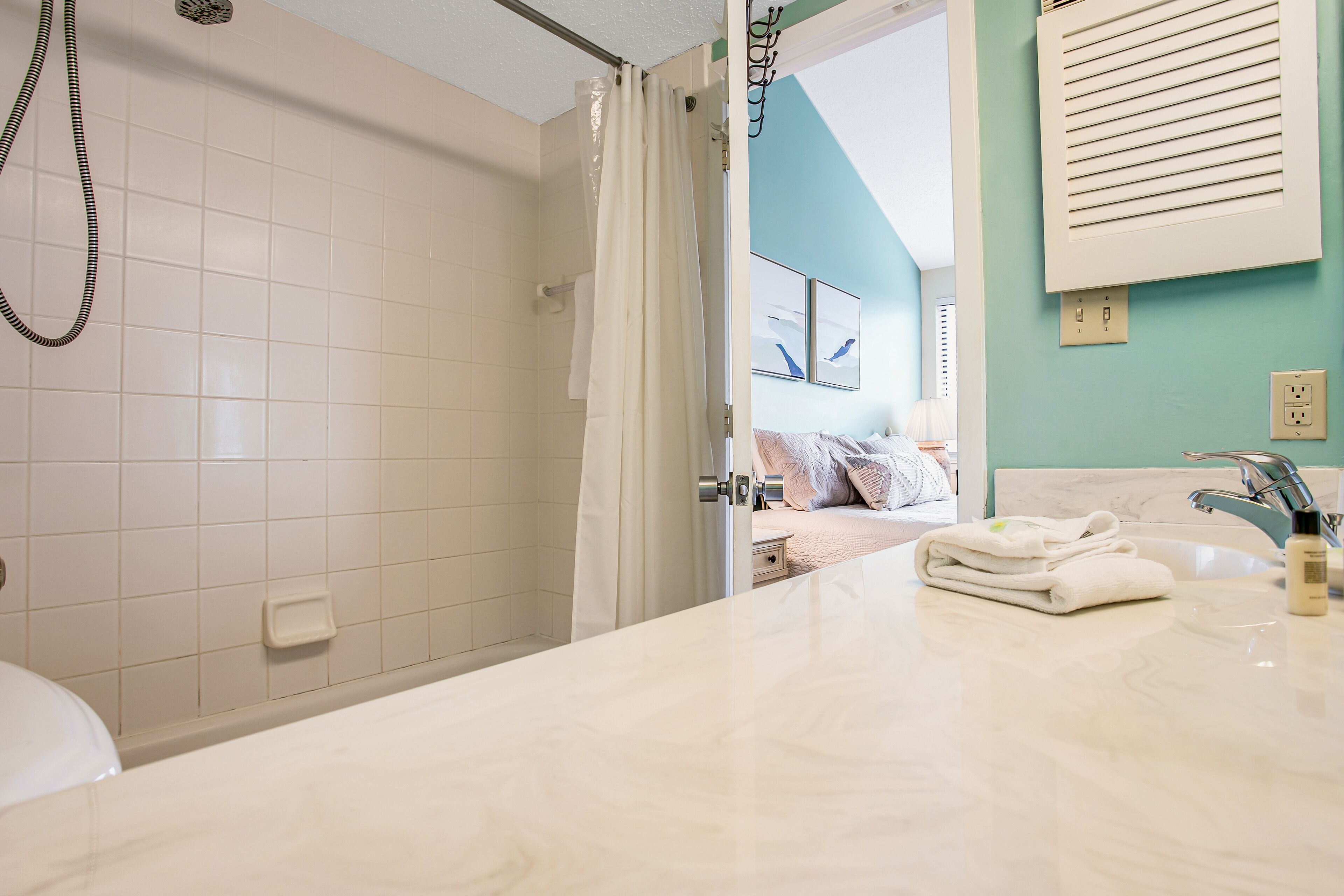 A bathroom with a shower, a sink, and a toilet.