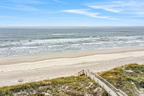 A beach with a wooden boardwalk leading to the shore, sandy beach, and ocean waves. - Oceanfront Condo With Pool, Grill, Central AC, Washer/dryer, & Snowbird Friendly (St. Augustine)