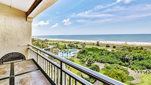 A balcony with a view of a beach and a swimming pool. - Oceanfront Condo With Spacious Balcony, Great Views, AC & Outdoor Pooloc (Fernandina Beach)