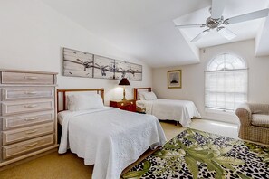 A bedroom with two beds, a dresser, a ceiling fan, a window with blinds, and a chair. - Oceanfront, Gated Community Townhome With Private W/d, Beach & Pool Access (Fernandina Beach)
