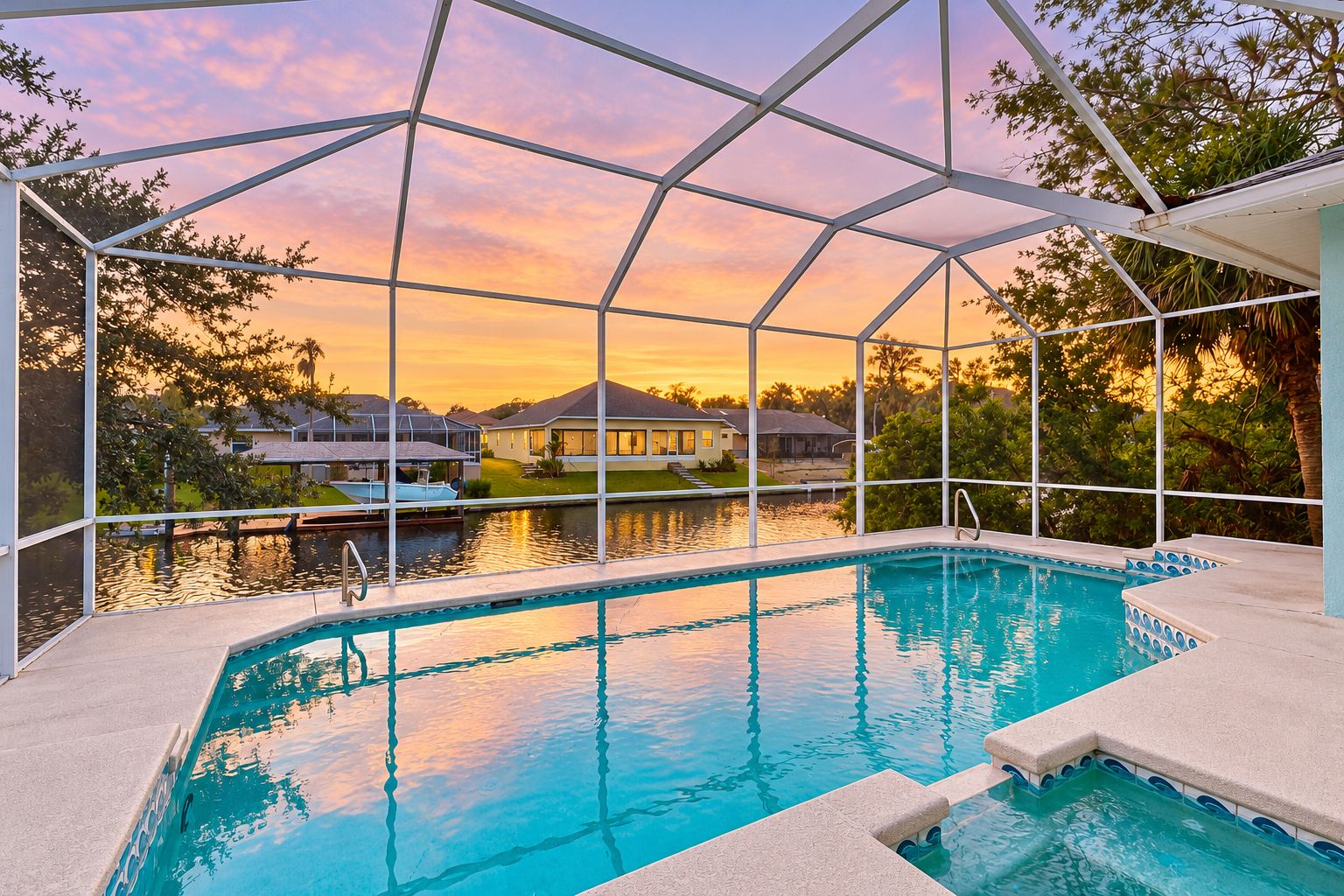A swimming pool with a view of houses and trees, enclosed by a white structure.