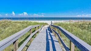 A wooden boardwalk leading to a beach with clear skies. - Oceanfront Condo With Large Balcony, Pool, Central AC & Views (Fernandina Beach)