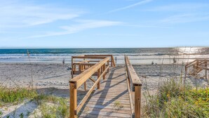 A wooden boardwalk leading to a beach with clear skies and calm waters. - Oceanfront Home w/ two Kitchens, Furnished Patio & Balcony, & Beach Access (St. Augustine)