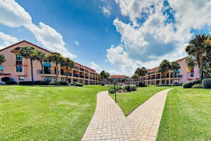 A hotel with a central courtyard, paved walkways, and multiple buildings with balconies. - Patio Condo in Oceanfront Community w/ Pool Walk to Beach (St. Augustine)