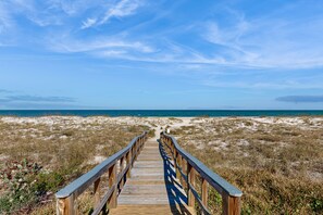 A wooden boardwalk leading to a beach with a clear sky. - Oceanfront Condo With Panoramic Views, Shared Pool, and Private Washer & Dryer (Fernandina Beach)