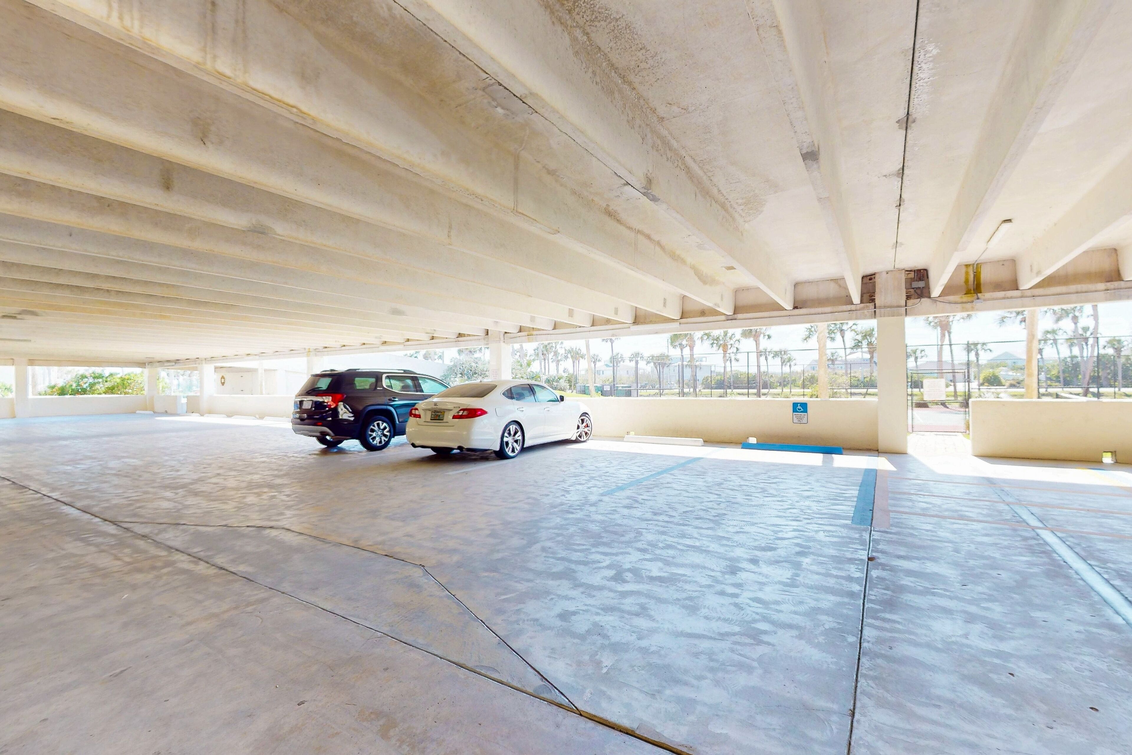 An indoor parking area with concrete floors and a high ceiling.