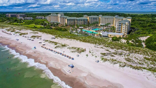 An aerial view of a resort with multiple buildings, a beach, and a swimming pool. - Relaxing Amelia Island Retreat 2br/2ba Condo in Amelia Island Plantation (Fernandina Beach)