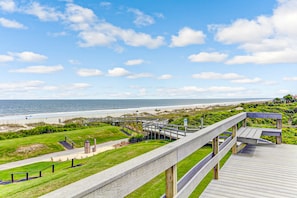A wooden boardwalk leading to a beach with a clear view of the ocean. - Spacious Condo With Beach Access, Balcony, AC & Outdoor Pool (Fernandina Beach)