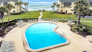 A swimming pool with lounge chairs, a pathway leading to the beach, and a view of the ocean. - Oceanfront Condo With Direct Beach Access, Shared Pool, Tennis (St. Augustine)