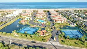 A coastal resort with multiple tennis courts, a central pool, and a beachfront view. - Sunny Ground-floor Condo W/private Patio, W/d, On-site Pools, Tennis Court, BBQ (St. Augustine)