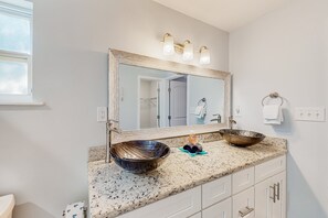 A bathroom with a large mirror, two sinks, and a vanity with drawers. - Updated Home With Great Outdoor Space - Close to the Beach (St. Augustine)