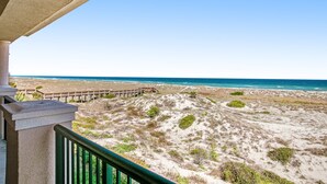 A balcony with a view of a beach and ocean. - Tranquil Coastal Home With Ocean Views, Beach Access, Balcony & Shared Pool (Fernandina Beach)