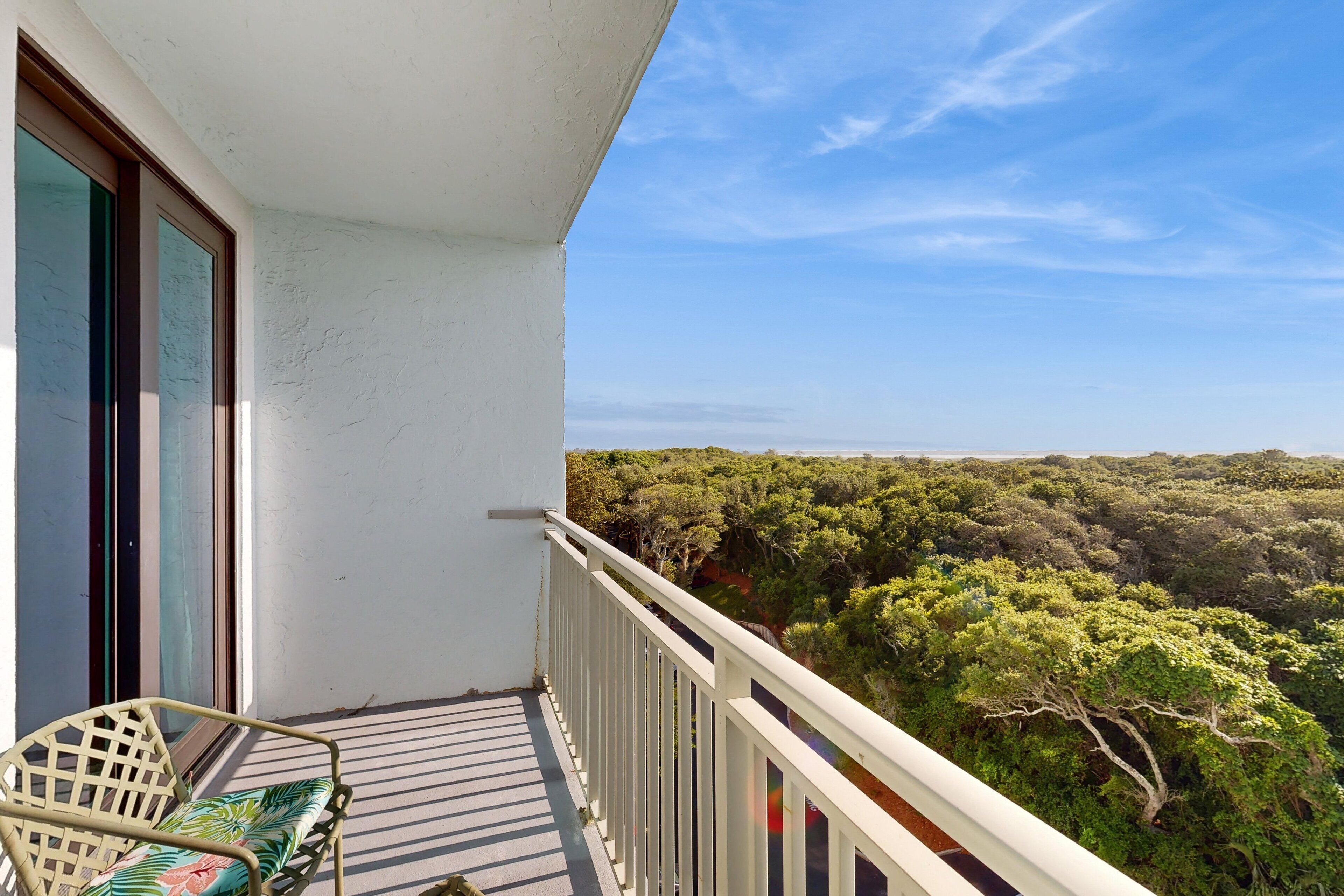 A balcony with a view of dense forest.