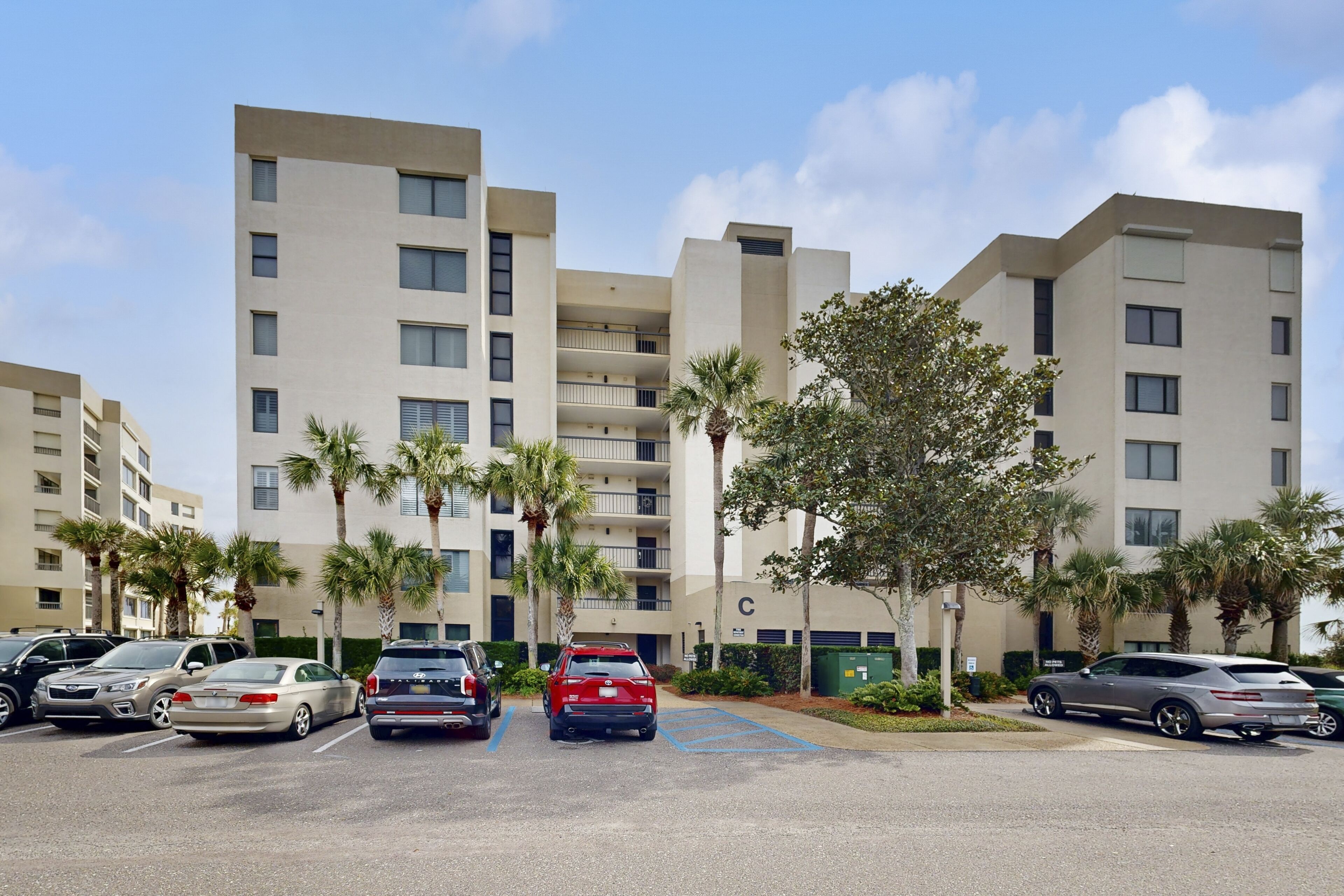 A multi-story parking garage with several cars parked.
