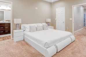 A bedroom with a bed, nightstands, a dresser, and a mirror. - Updated, Dog-friendly gem W/fenced Yard, Foosball & Pool Tables, Wifi, Fireplace (St. Augustine)