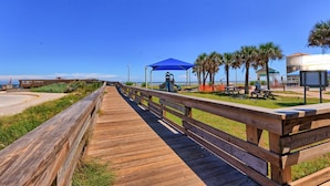 A wooden boardwalk leading to beachside amenities, including picnic tables and a covered area. - Updated Oceanfront, Oceanviews! 5 Hot Tubs 2 Resort Pools! Trolley St Augustine Beach (St. Augustine)