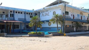 A two-story building with a sign reading "BUNGALOWS ALDAZ".